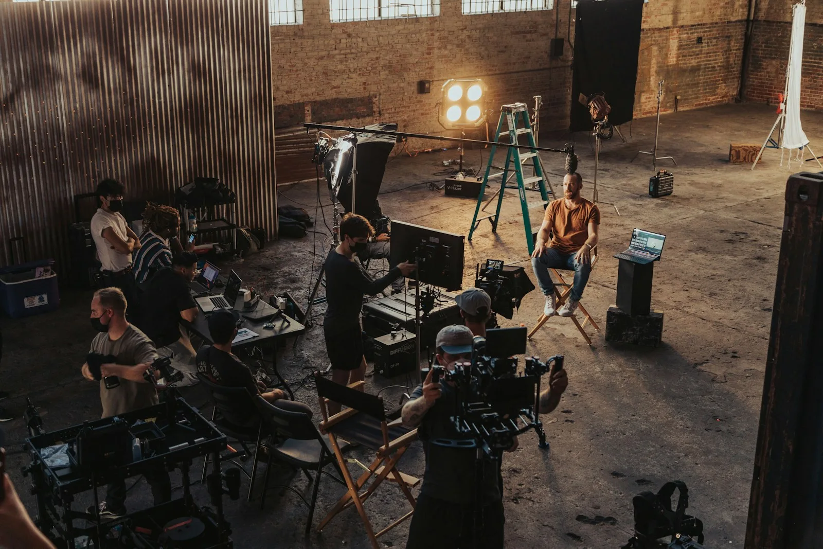 a group of people standing around a camera set up