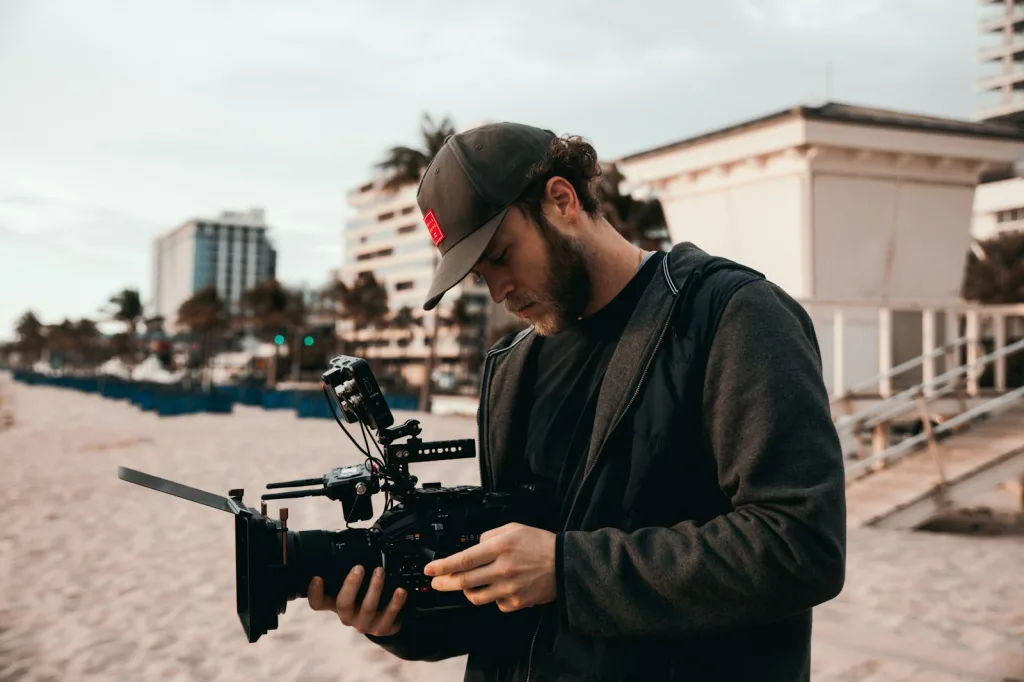 man in black jacket holding black video camera